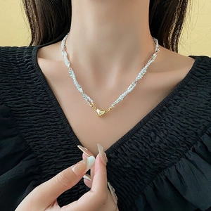 Faux pearl heart necklace featuring a magnetic gold pendant on a beaded layered chain