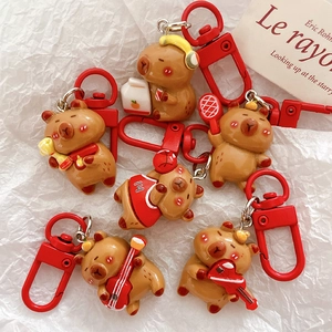 Cute capybara cartoon keychains with various accessories and red metal lobster clasps