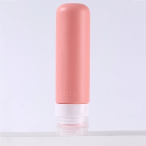 Pink 100ml silicone travel squeeze bottle with white flip cap for toiletries