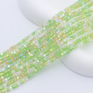 Macro view of 2mm square glass beads in light green and yellow for DIY jewelry making