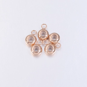 Macro view of five rose gold stainless steel slider beads with clear silicone inserts