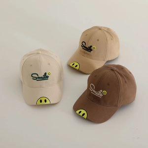 Detail showing embroidered smile and smile face on cotton baseball cap brim