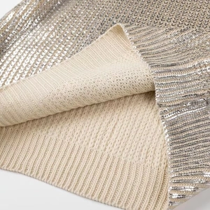 Women's crew neck sweater featuring beige knit lining and silver sequin outer texture