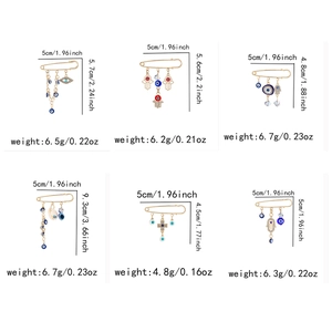 Detailed grid view showing sizes and weights of six gold evil eye tassel brooches