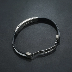 Detail of black and white silicone strap with silver stainless steel folding clasp