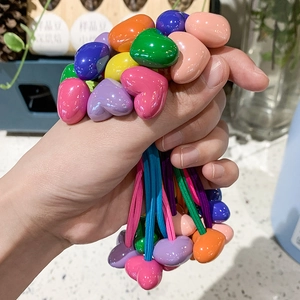 Close-up of colorful heart-shaped hair ties set in vibrant glossy resin materials