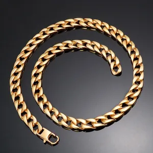 Close-up of high-polish gold Cuban link necklace showing the flat interlocking rings on black