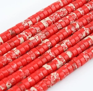Macro detail of red and white marbled flat disc beads for handmade jewelry DIY