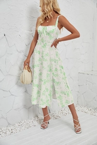 Detail of white floral sundress featuring green print and stylish side slit design