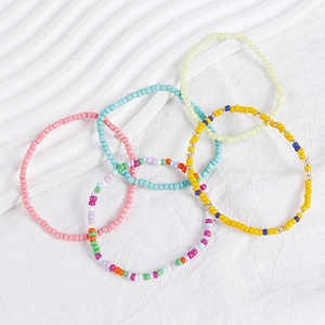 Close-up of mixed color Bohemian beaded bracelet set with five vibrant layered styles