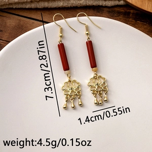 Detail view of red beaded Chinese earrings showing 7.3cm length and flower design
