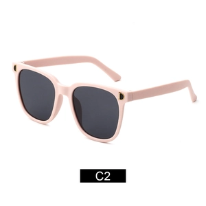 Fashionable pink square kids sunglasses with dark lenses and gold D metal logo on temples