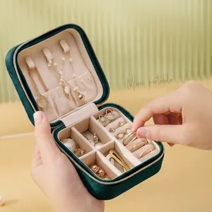 Mini portable dark green velvet jewelry travel case with multiple storage compartments