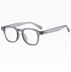 Close-up of translucent grey oval sunglasses with silver rivets and anti-slip temple tips