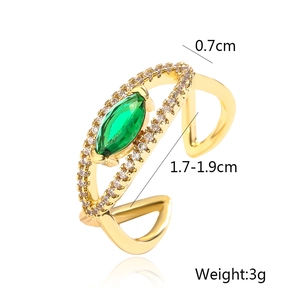 Detail view of gold-plated open ring with green marquise gem and clear zircon pavé stones