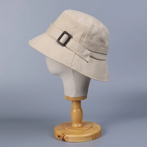 Beige cotton bucket hat with buckle strap detail for sun protection in summer