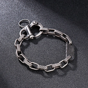 Detail of vintage steel chain bracelet with lobster clasp and engraved rectangle tag