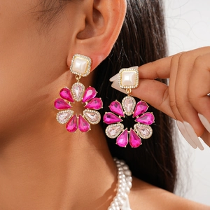 Detail of luxury baroque flower earrings with pink rhinestones and white pearls