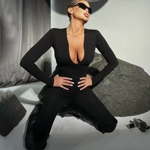 Close-up of black long sleeve slim fit bodysuit with deep V-neck design on model