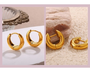 Detailed view of chunky gold hoop earrings with polished finish and hinge closure
