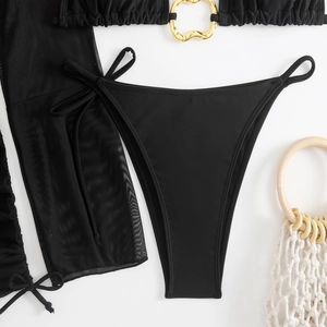 Detail of black bikini with gold heart ring accents and mesh sarong cover-up
