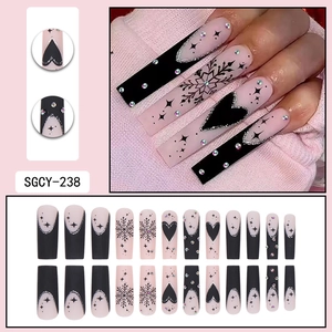 Matte black French tip press-on nails with heart, snowflake, and silver glitter details