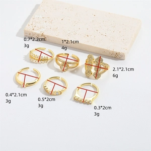 Set of six adjustable gold zircon rings in French vintage style on a textured stone base