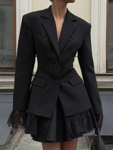 Slim fit black blazer with delicate lace hem and sleeve details on European city background