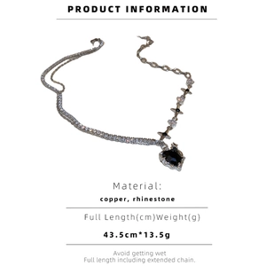 Detail view of double-layered heart necklace with copper and rhinestone material specs