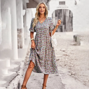 Blue floral V-neck short sleeve midi dress for women shown in an exotic stone alley
