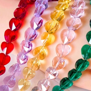 Macro detail of faceted crystal heart beads in vibrant colors for DIY jewelry making