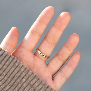 Minimalist gold S925 sterling silver cross ring with PRAY engraving on model hand
