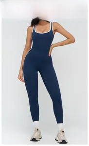 Detail view of the contrasting white trim on a navy blue sleeveless yoga jumpsuit