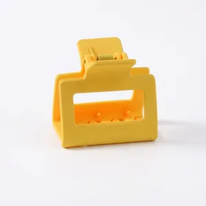 Close-up of bright yellow matte claw clip showing the durable ABS spring mechanism