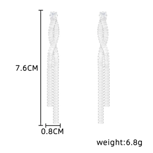 Detail view of long tassel earrings with dimensions 7.6cm length and 6.8g weight