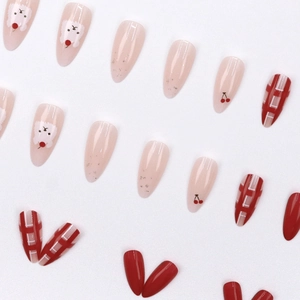 Kawaii almond press-on nails featuring red cherries, bears, and red white plaid patterns
