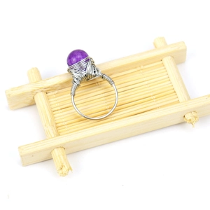 Handmade silver wire wrapped ring featuring a natural round purple amethyst crystal bead