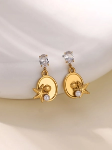 Detail of gold ocean-style starfish and shell earrings with pearls and zircon