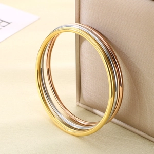 Set of three minimalist stackable 3mm stainless steel bangles in gold, silver and rose gold