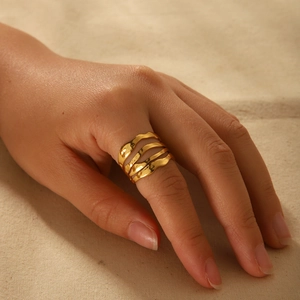 Minimalist gold plated multi-layer wavy ring featuring a textured lava pattern on model