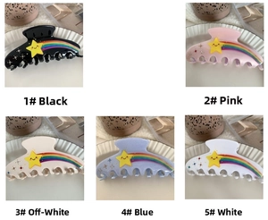 Detail view of five colorful star and rainbow acetate hair claws with sparkling rhinestones
