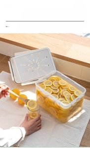 Transparent airtight food storage container for pickling lemons on a wooden countertop