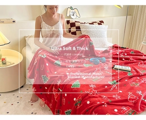 Close-up of thick red Christmas flannel blanket with festive holiday patterns and soft texture