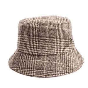 Close-up of vintage brown plaid wool bucket hat with detailed metallic logo accent