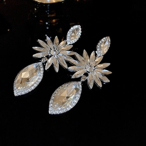 Close-up of elegant floral drop earrings with sparkling rhinestones and silver finish