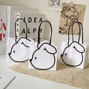 Minimalist white paper gift bags with cute dog patterns and black rope handles set