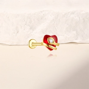 Close-up of S925 gold earring featuring a red heart stone and a serpent design