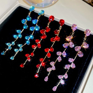 Detailed close-up of water drop leaf fringe earrings with vibrant zircon stones
