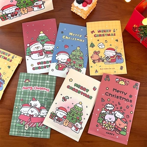 Flat lay of colorful Christmas paper envelopes with cute cartoon animals and holiday trees