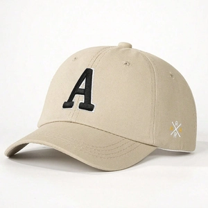 Detail view showing black embroidered letter A on a beige twill cotton baseball cap